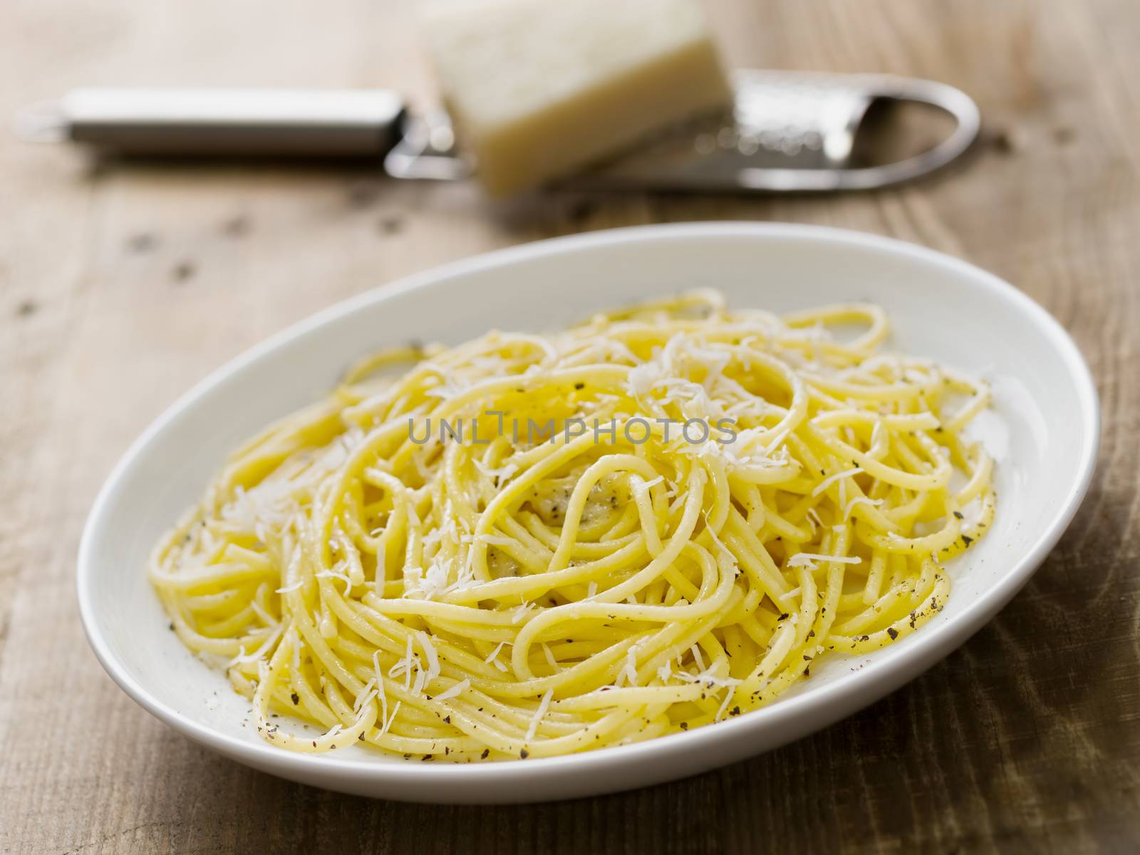 close up of rustic italian pepe e cacio pepper with cheese spaghetti