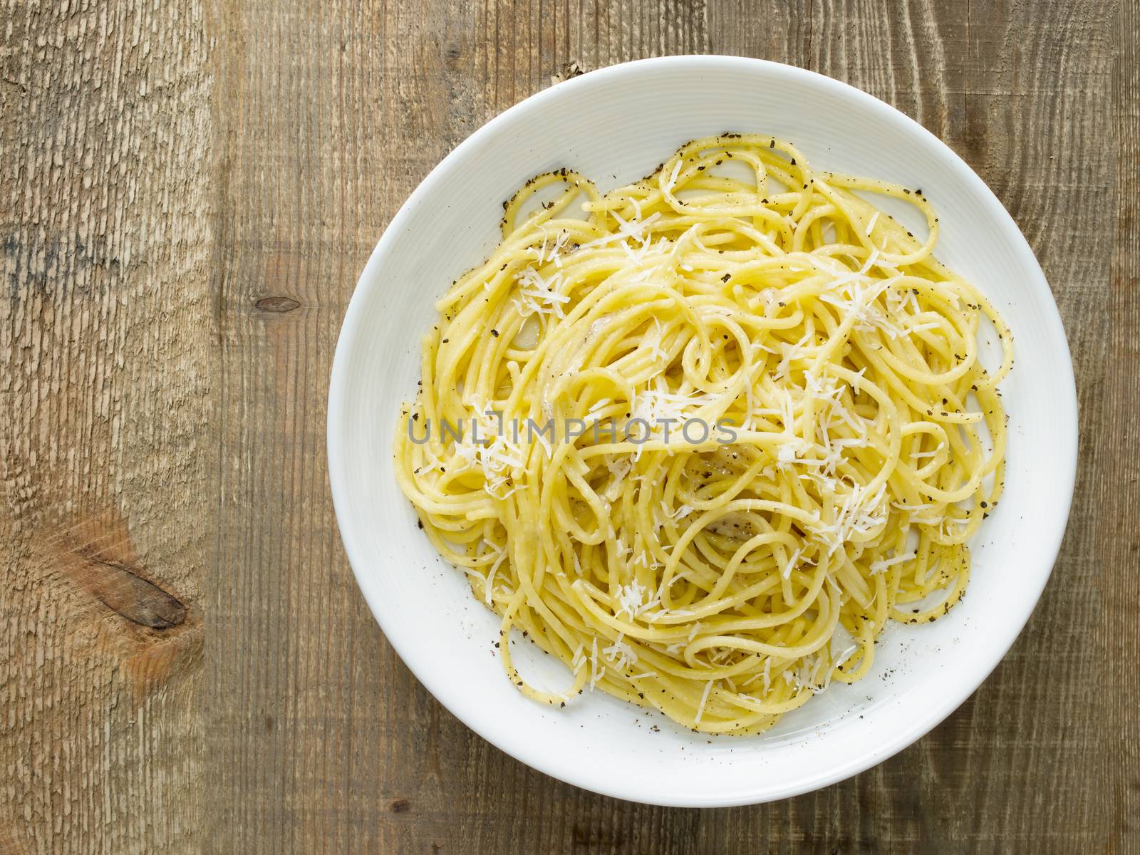 close up of rustic italian pepe e cacio pepper with cheese spaghetti