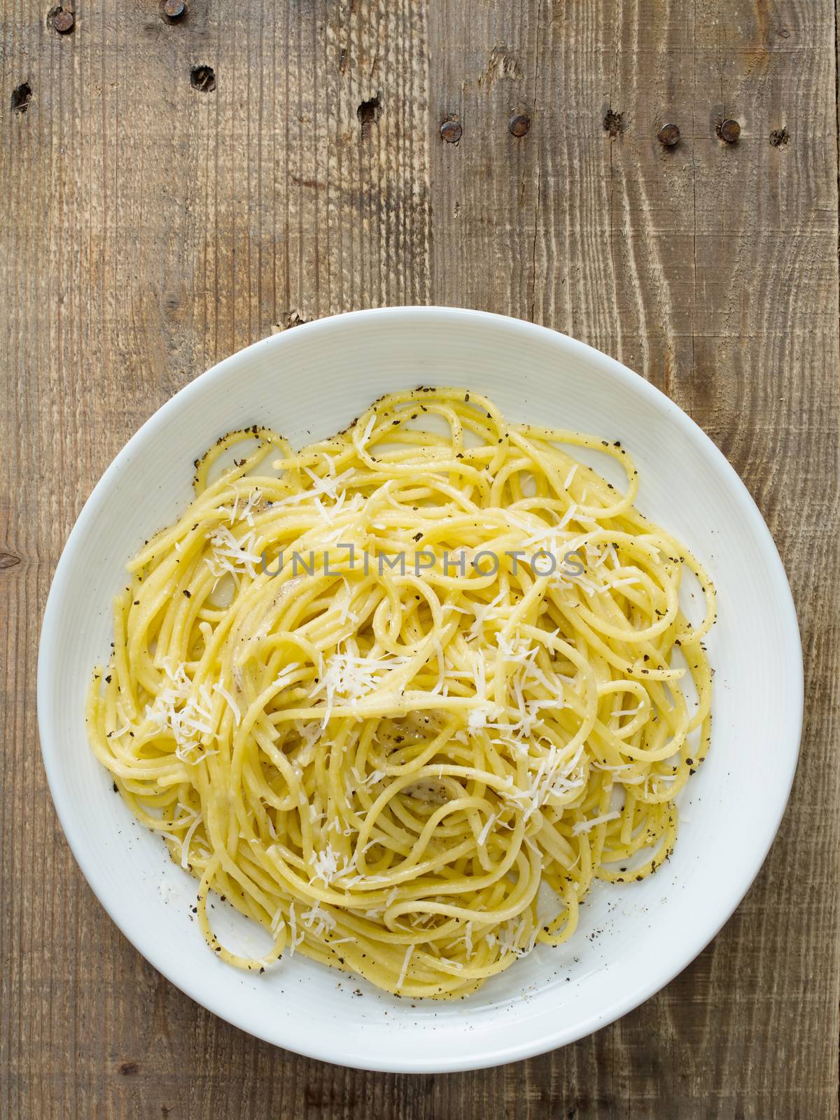 close up of rustic italian pepe e cacio pepper with cheese spaghetti