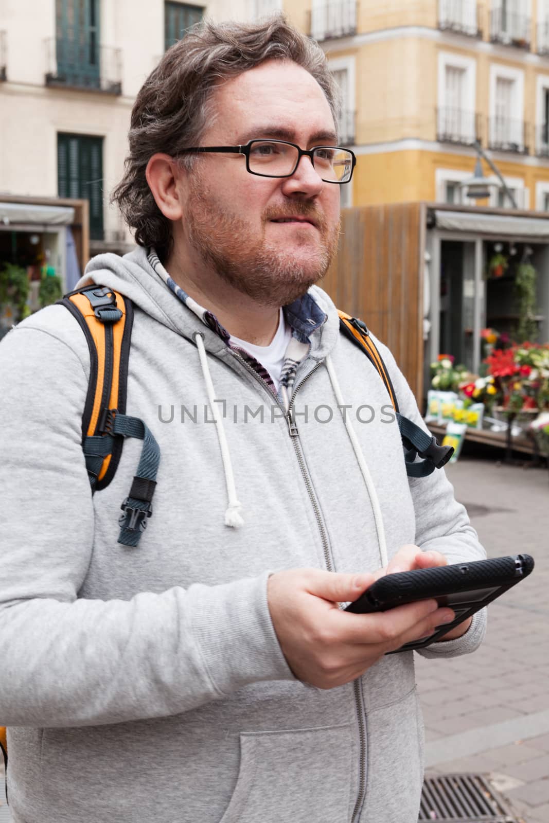 Young man with glasses in looking his mobile device