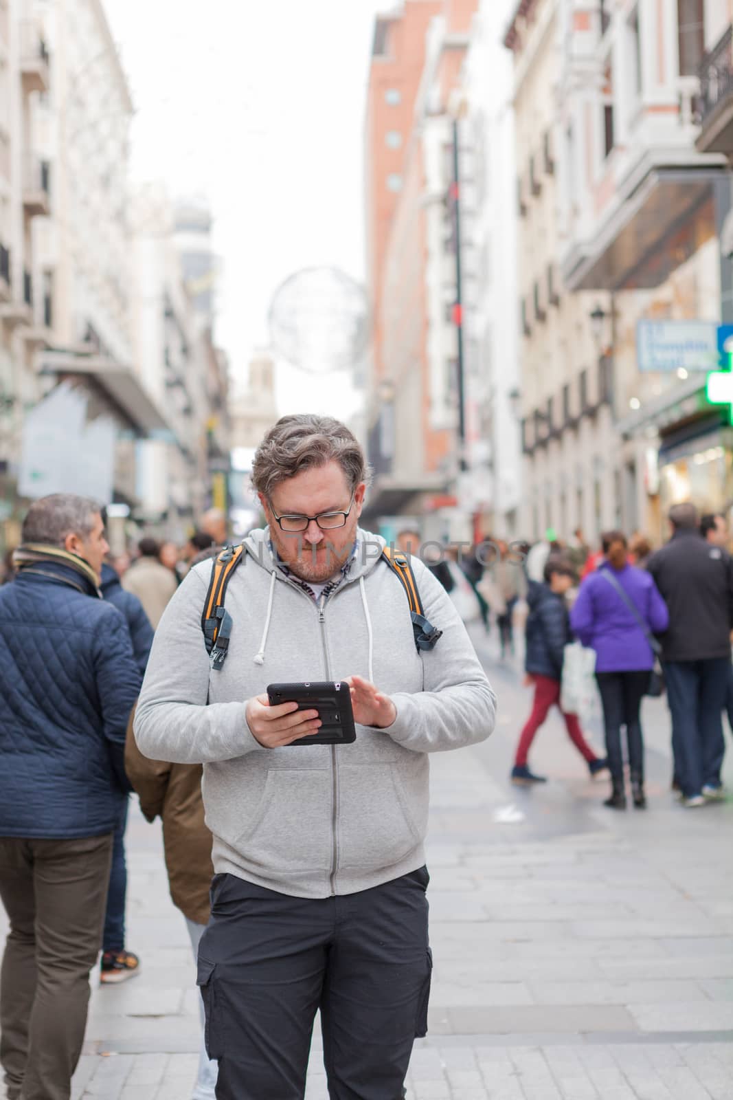 Young man with glasses and  bearded browsing Internet by andongob