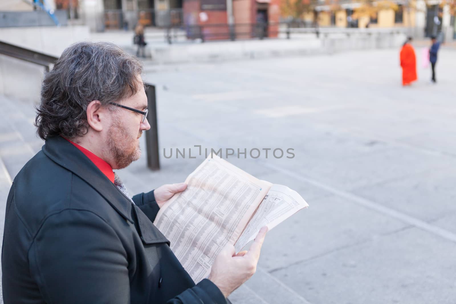 Young businessman with a newspaper by andongob