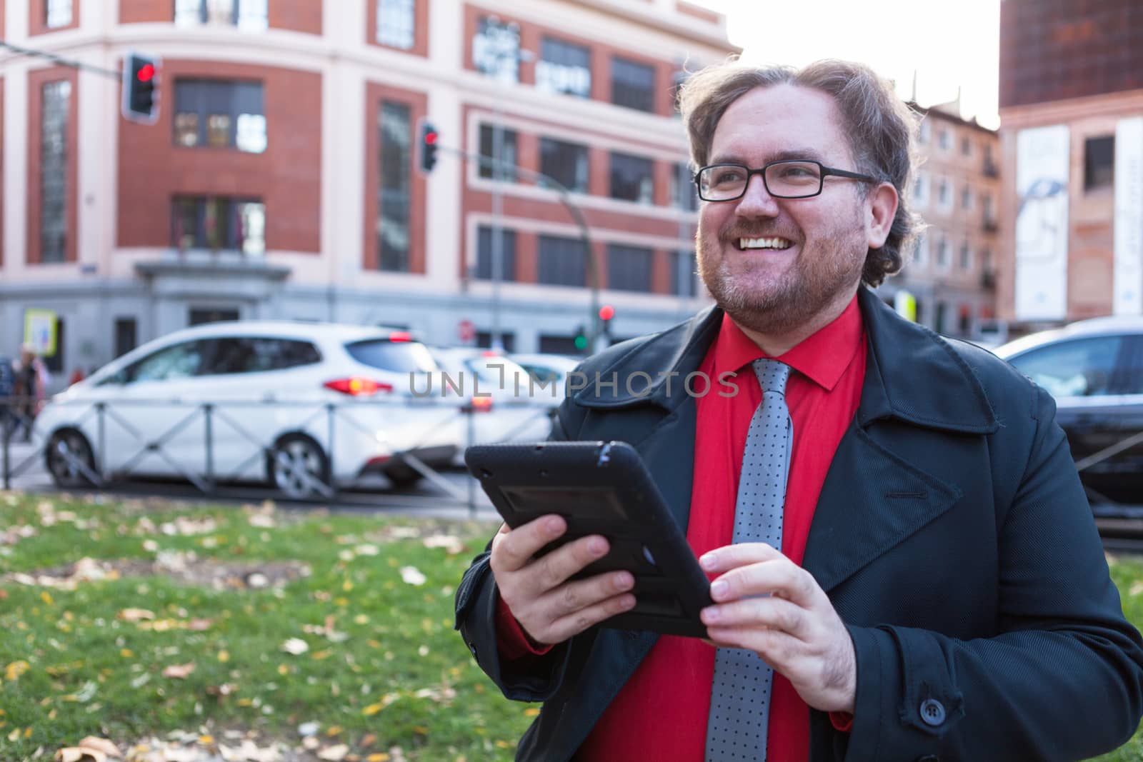 A young businessman with glasses in a urban scene