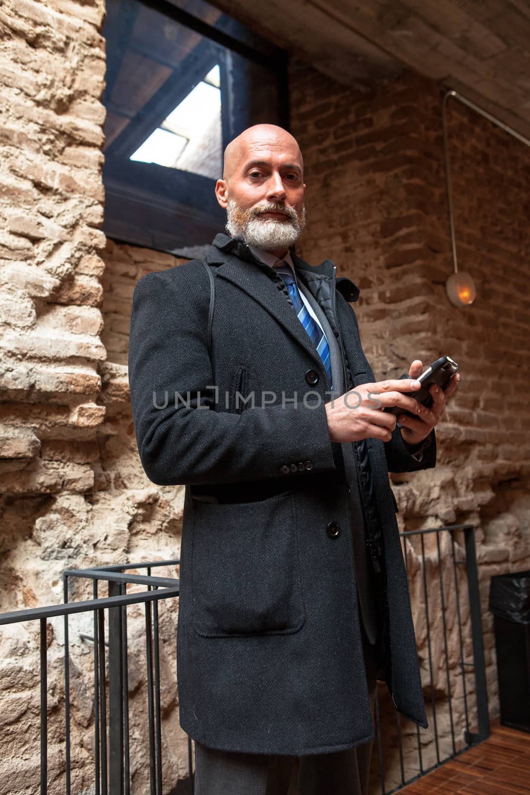 Middle-aged man , handsome and elegant working outside the office in a relaxed atmosphere