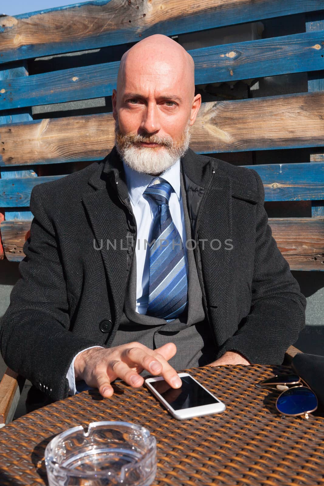 Middle-aged man , handsome and elegant working outside the office in a relaxed atmosphere