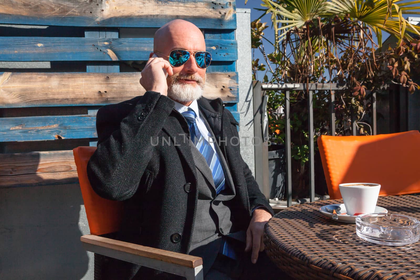 Middle-aged man , handsome and elegant working outside the office in a relaxed atmosphere