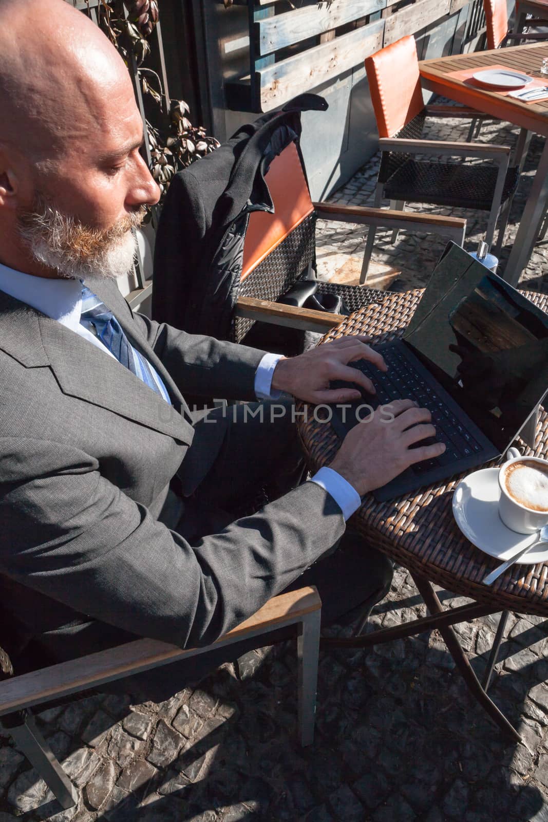 Middle-aged man , handsome and elegant working outside the office in a relaxed atmosphere