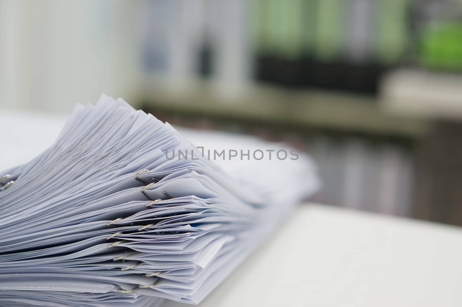 Stack of data document are placed on desk in office.