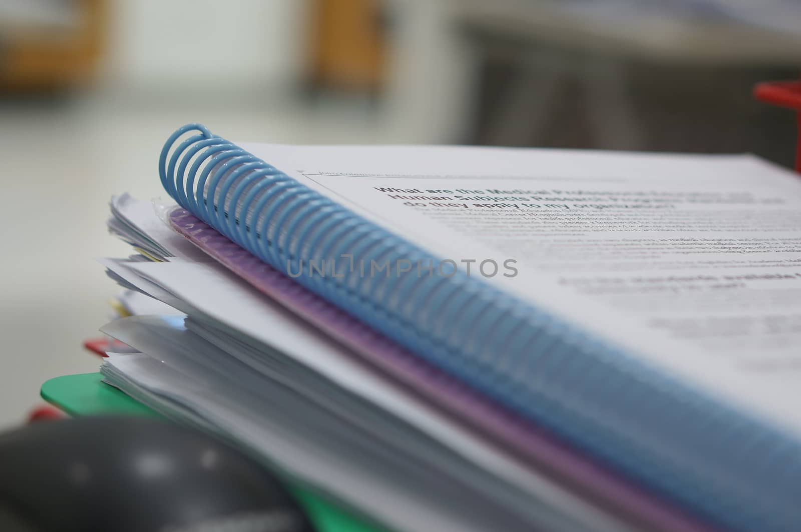 Spiral book and stack of data document place on desk in office.