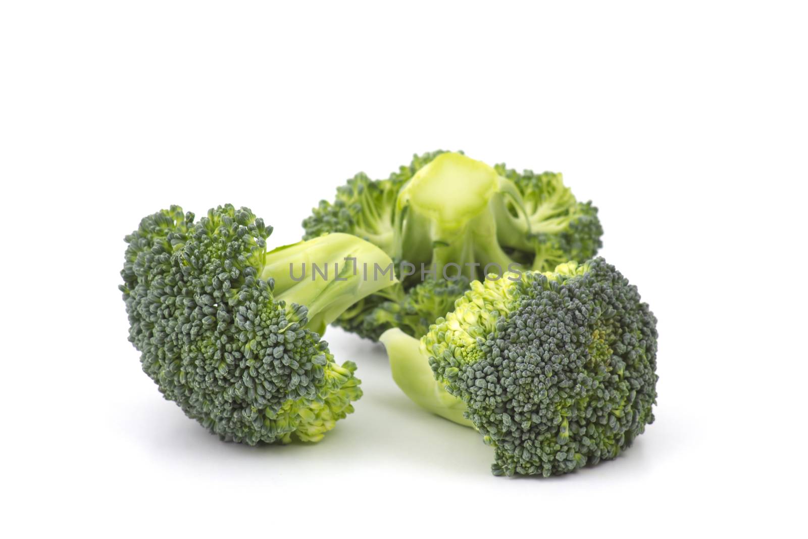 Raw broccoli on white background by miradrozdowski
