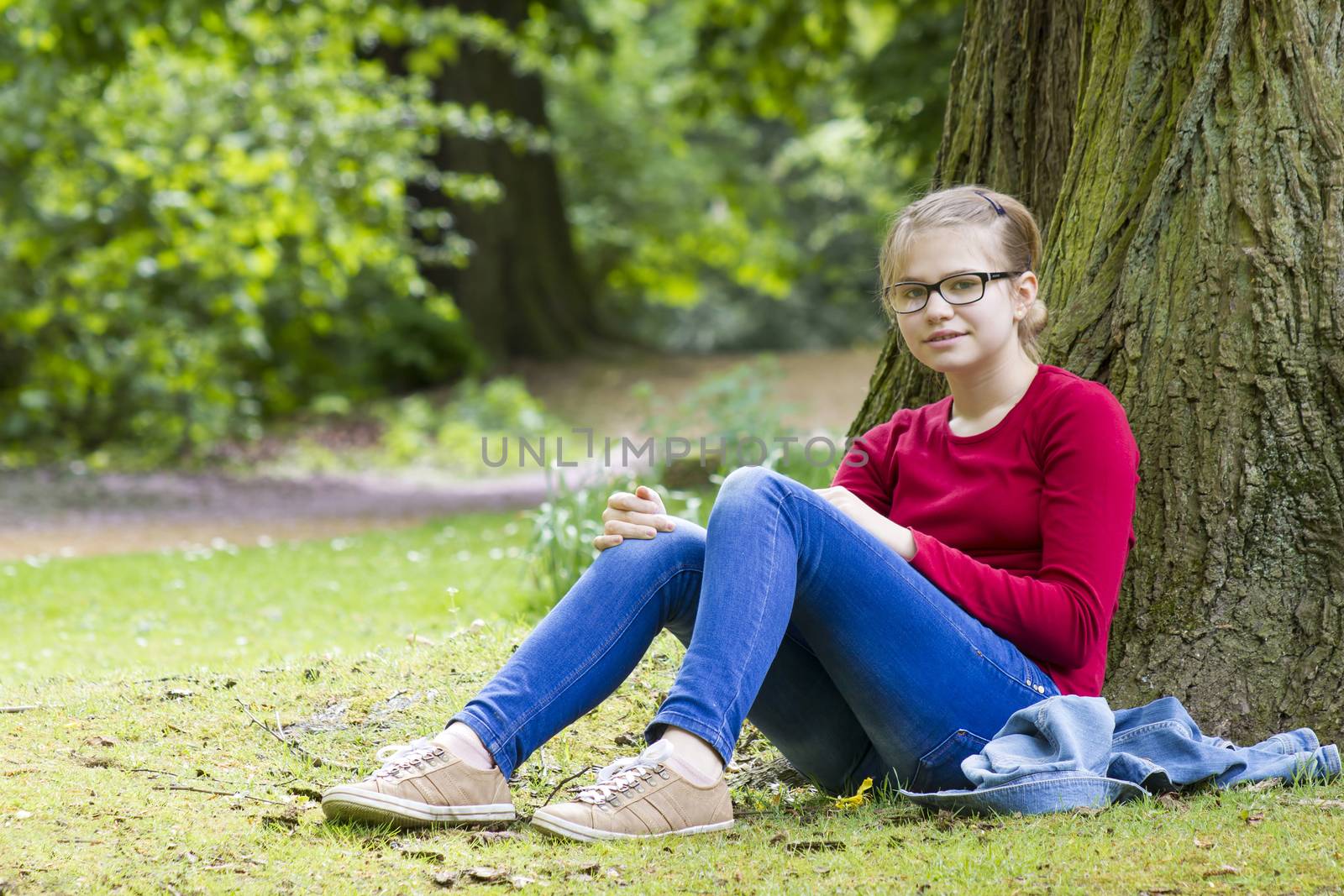 Young girl resting in park in spring day