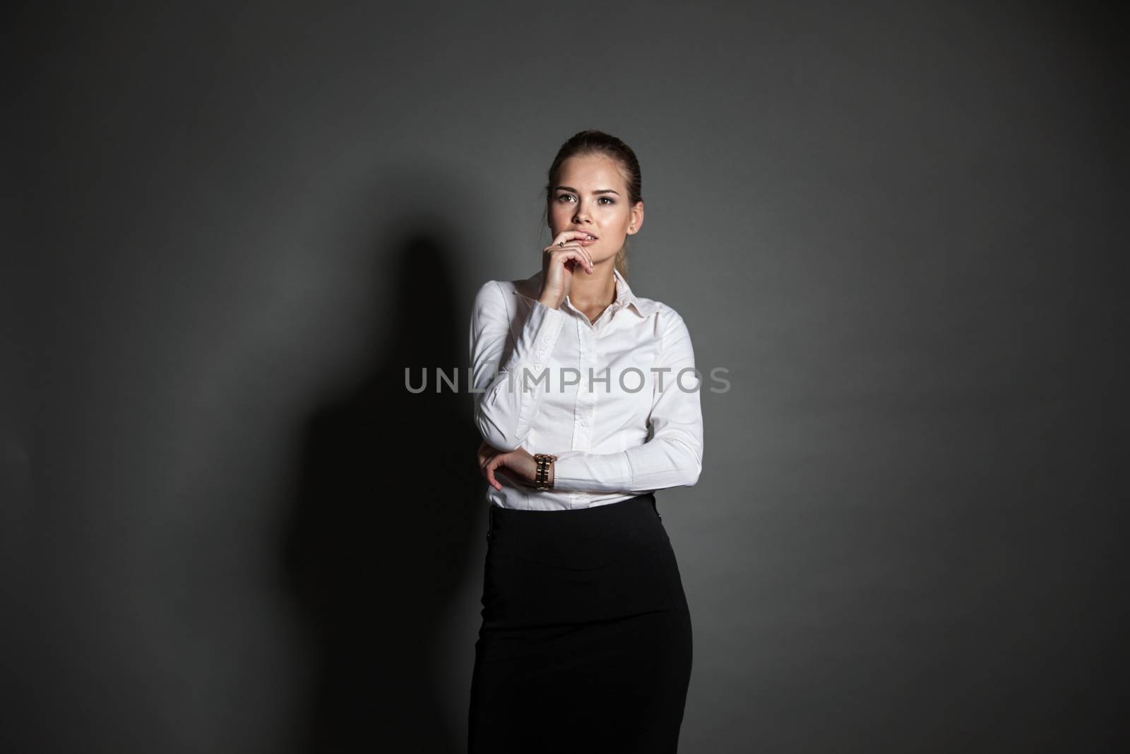 Portrait of young businesswoman on dark background