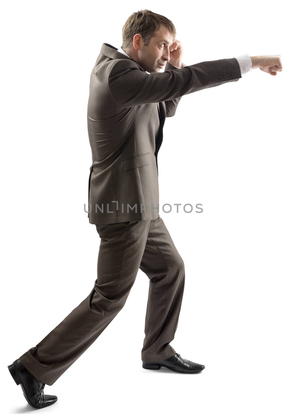 A man in suit punching and standing on white background