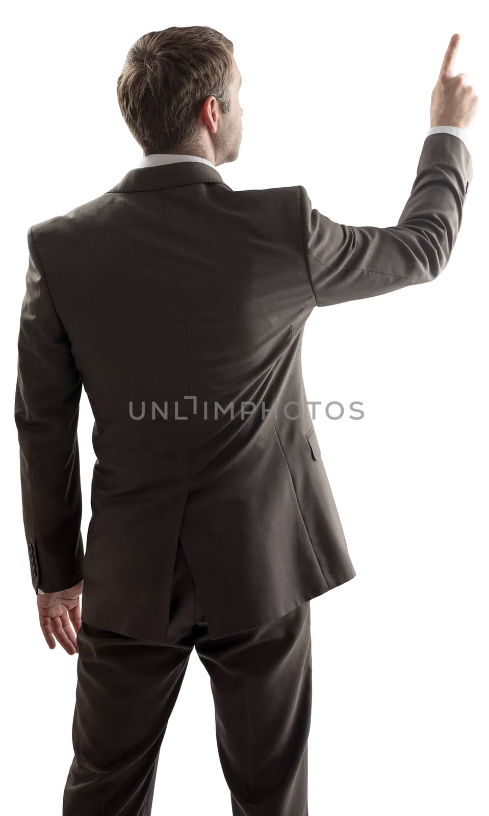 Rear view of businessman pointing at copy space  by cherezoff