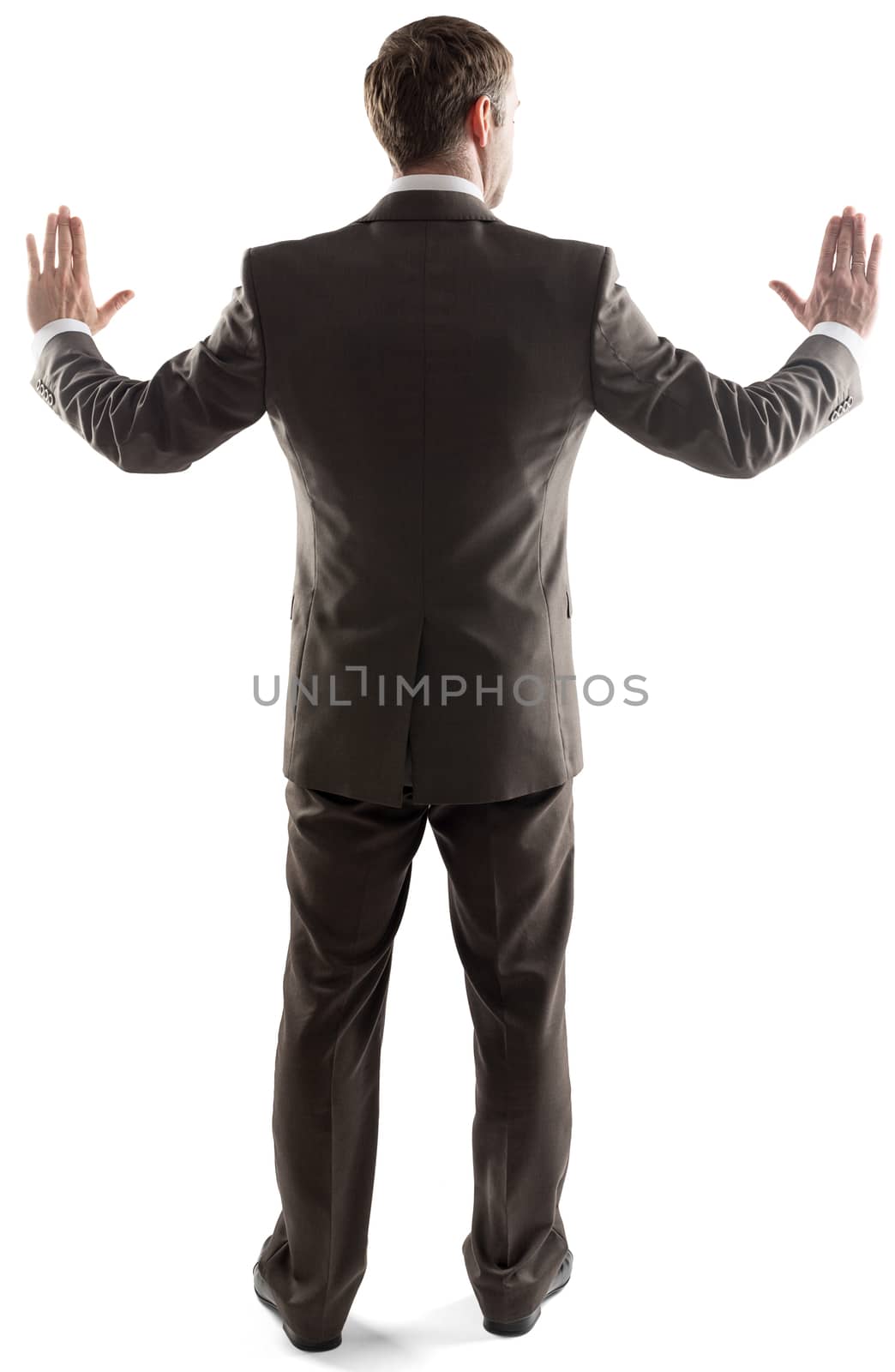 Rear view of young business man touching copy space isolated over white background