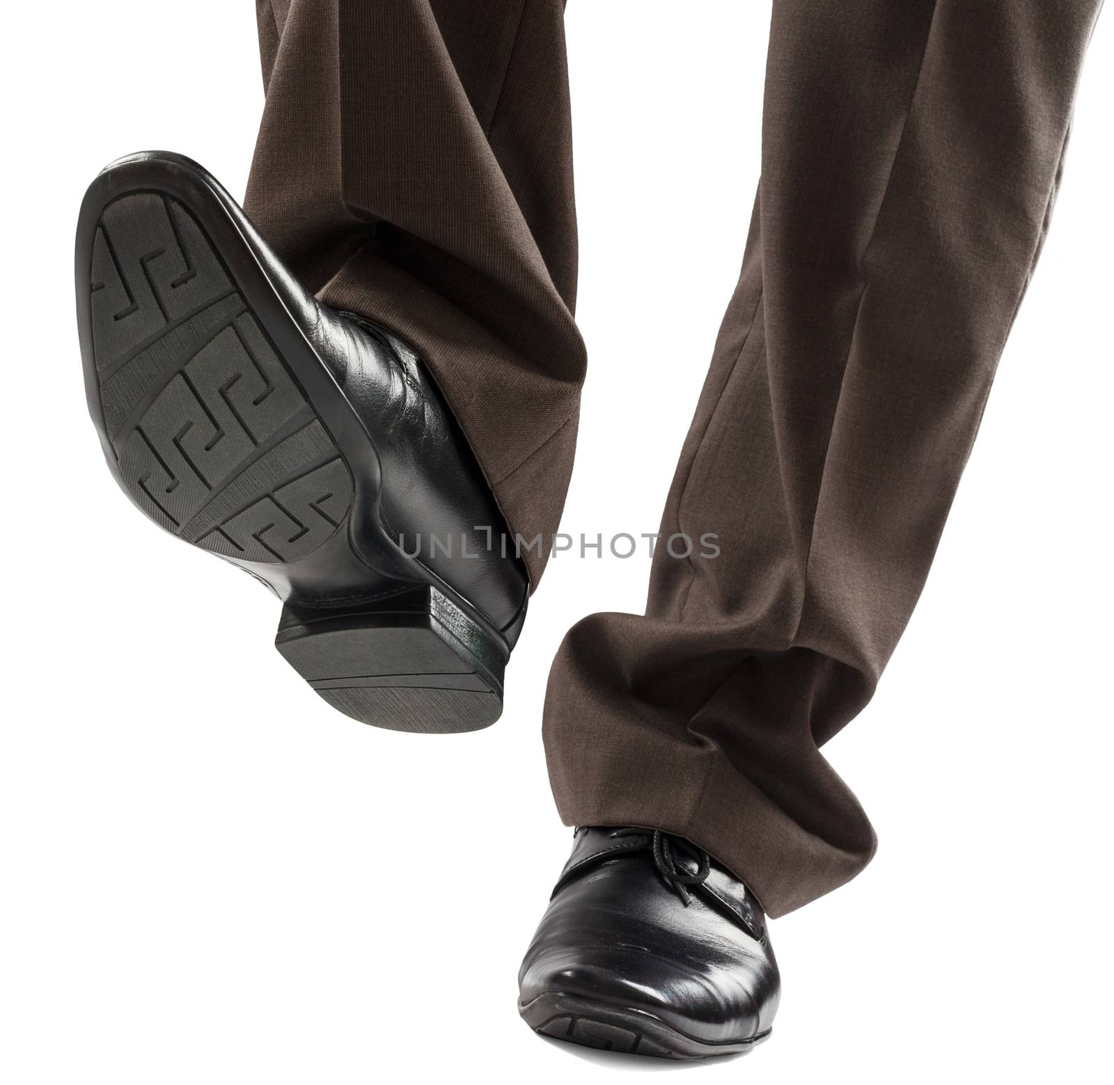 Shoes and legs of businessman caution step by cherezoff