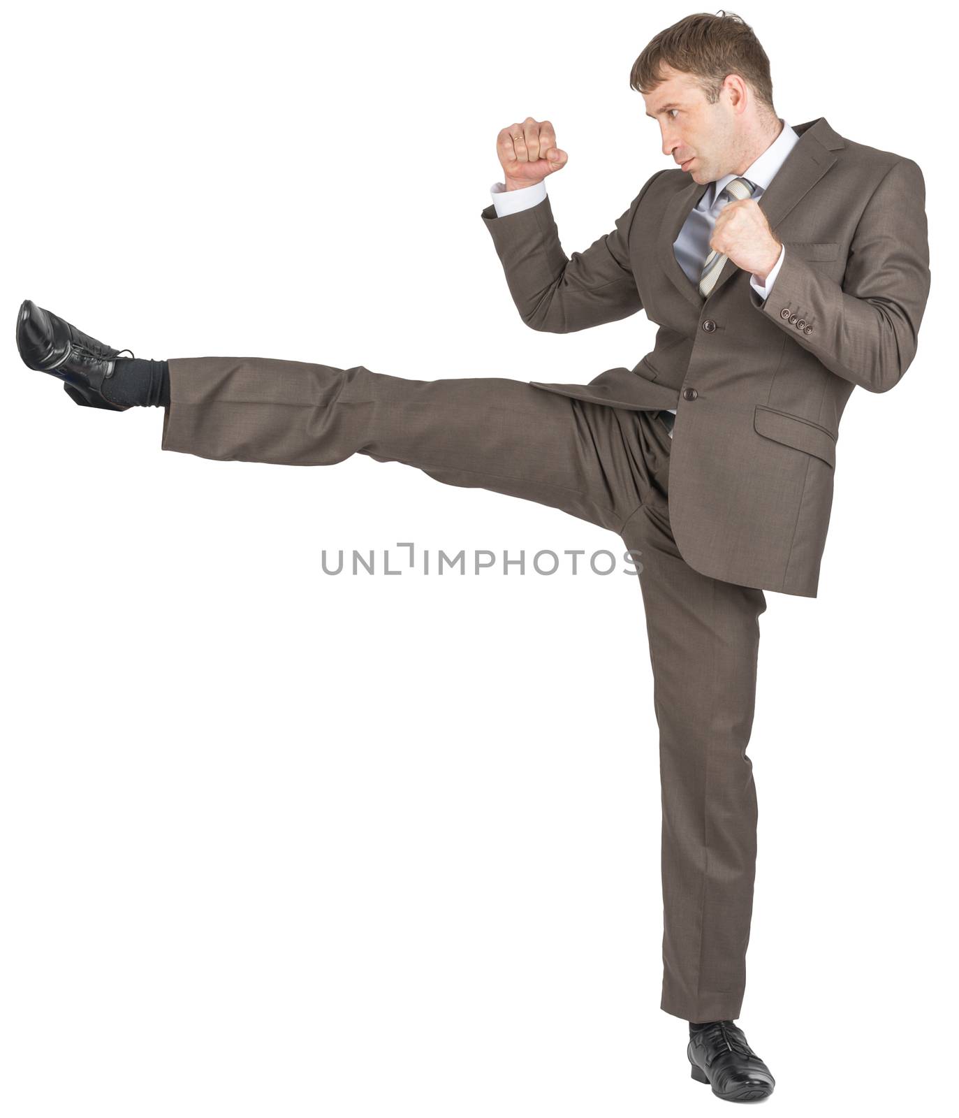 Businessman in suit kicking isolated on white background