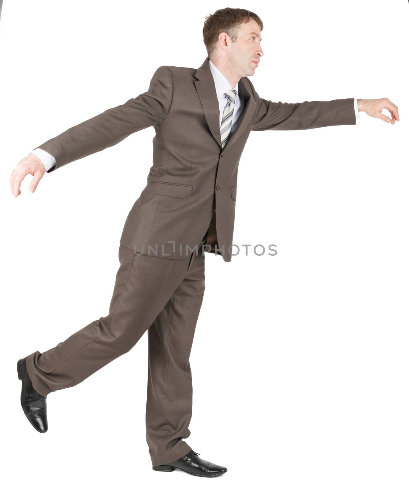 Businessman balancing on one leg isolated on white background