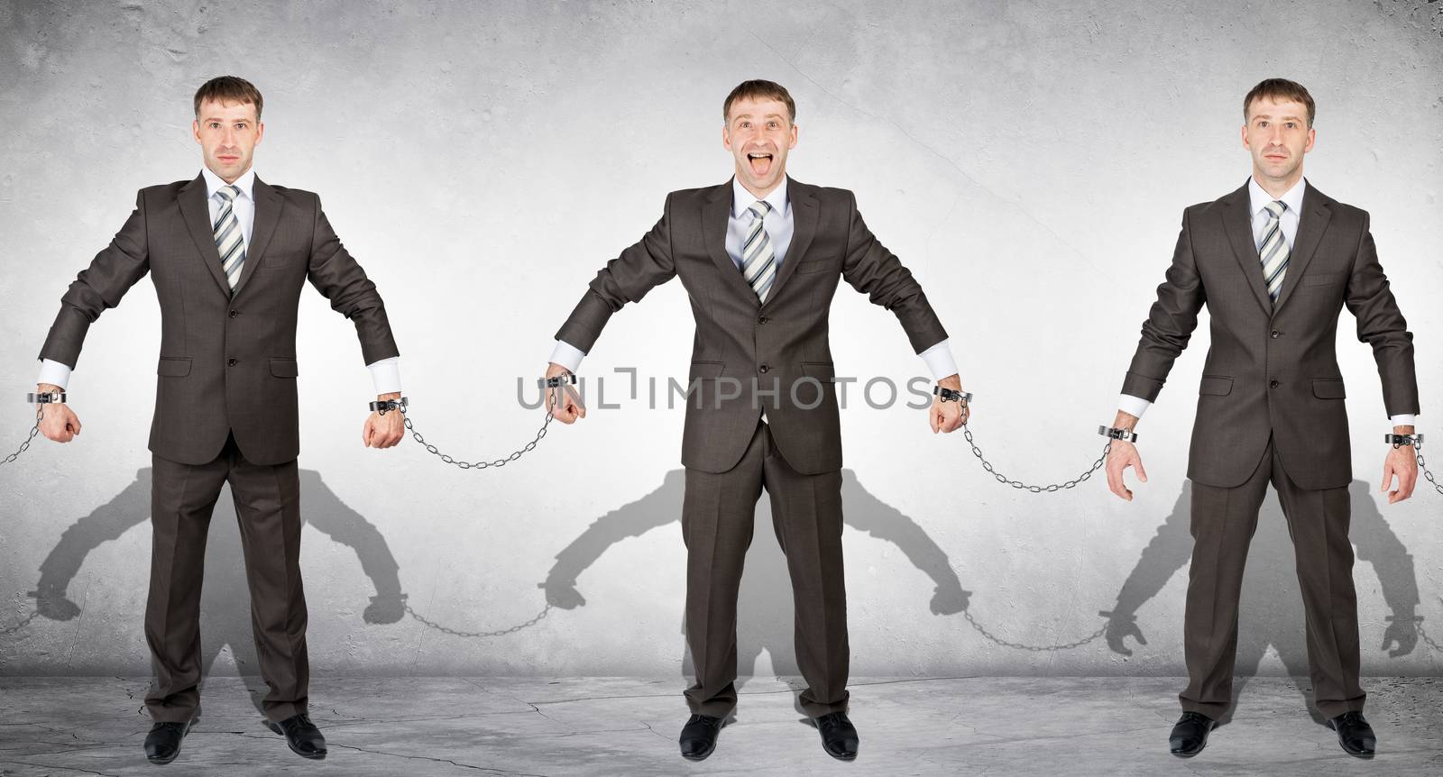 Set off businessmen in handcuffs on grey background