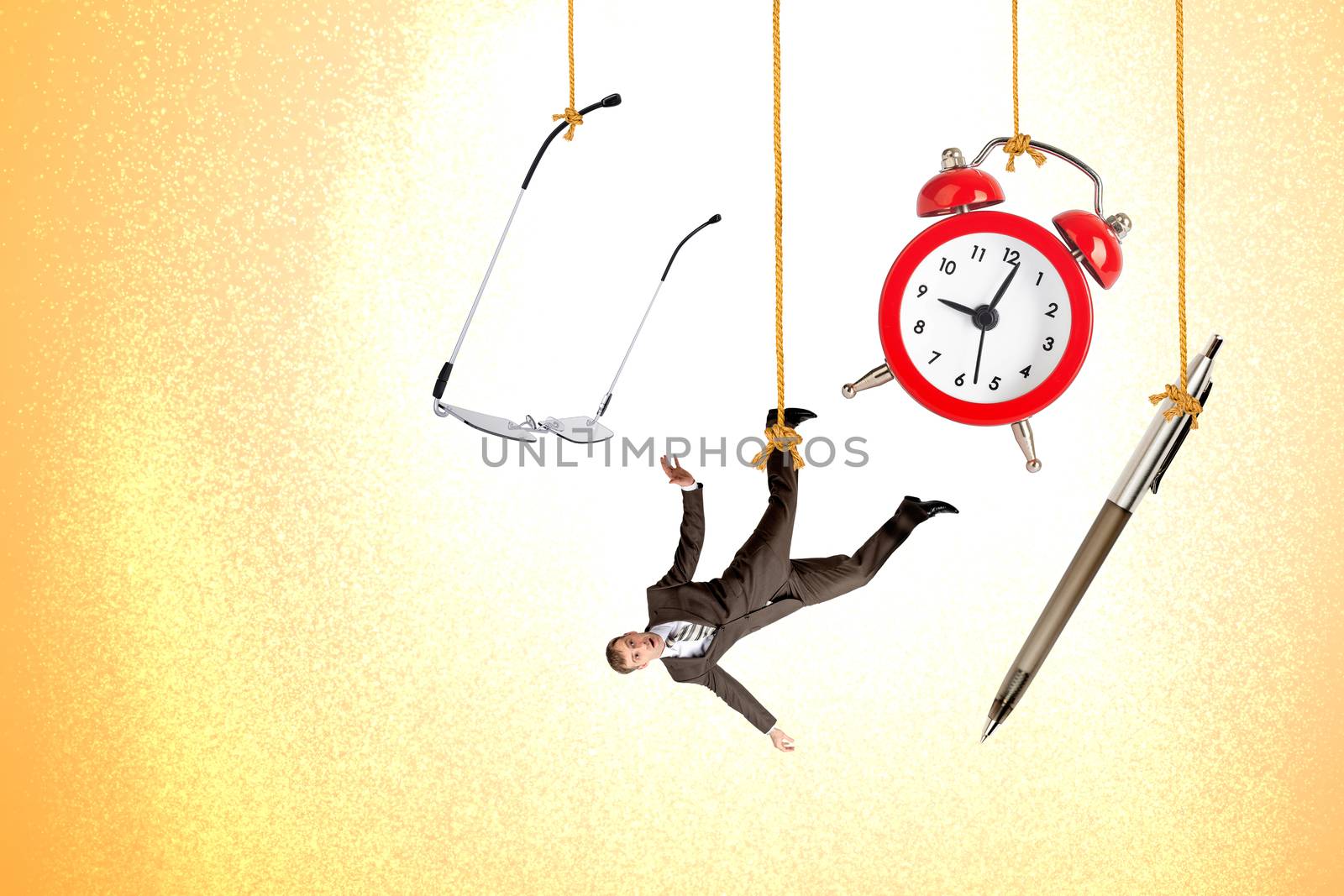 Man hanging on rope with clock, pen and glasses on colorful background