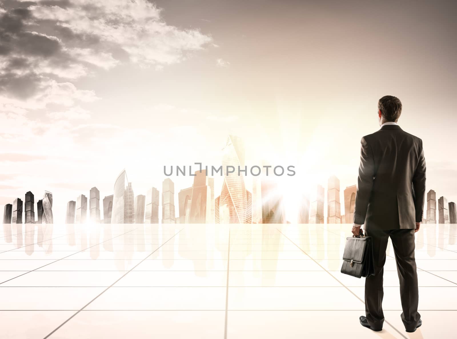 Businessman standing with back against morning city panoramic view