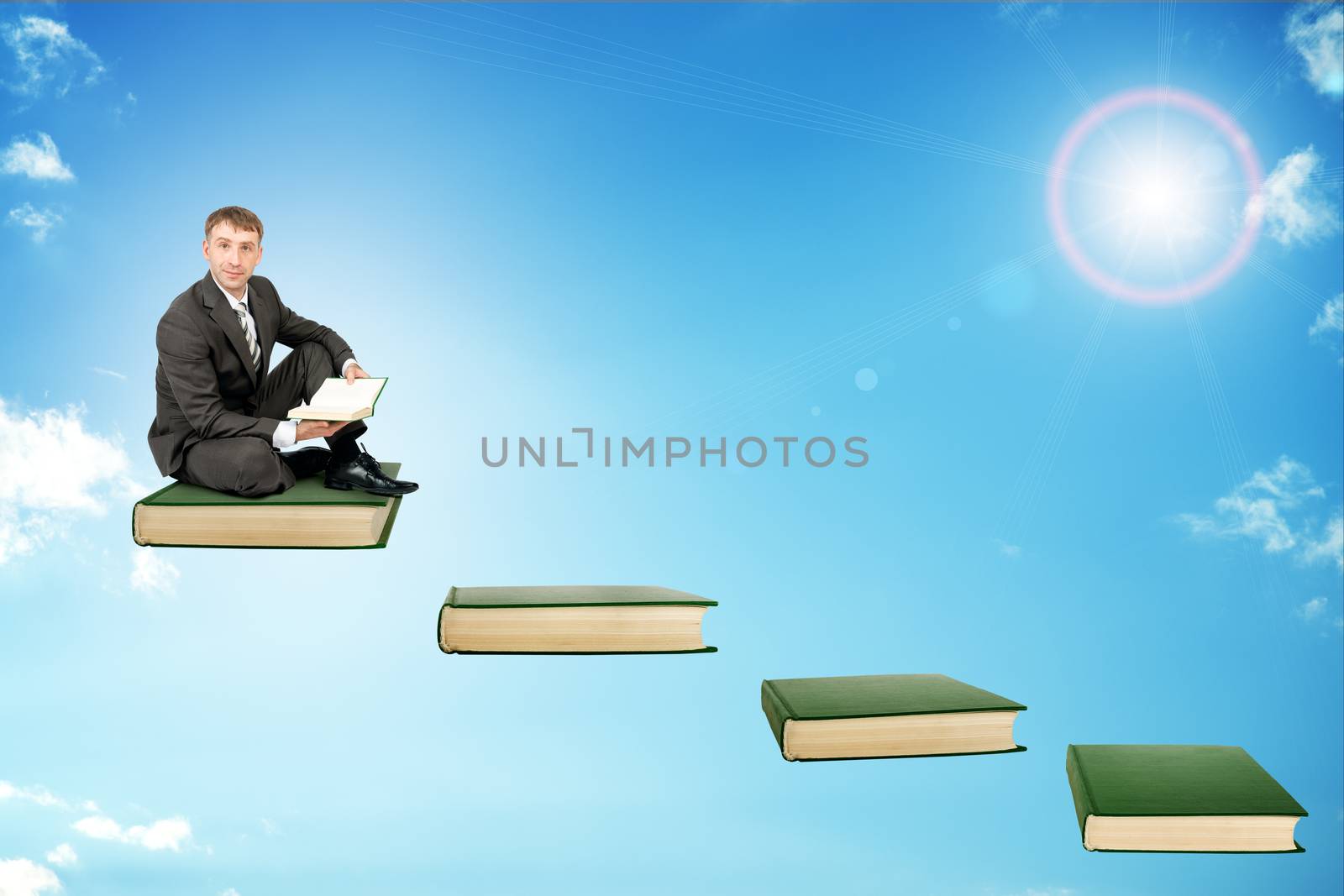 Young man in sitting on ladder steps with book in hands in sky