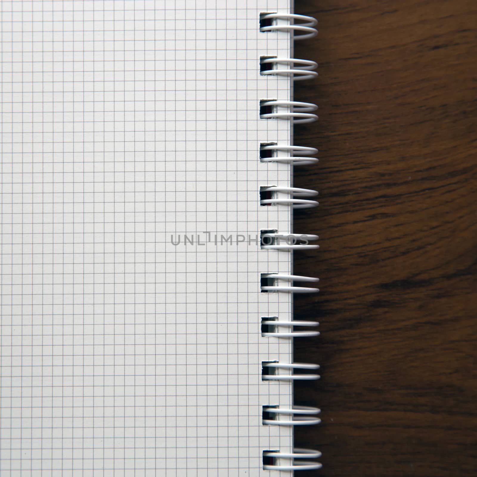 Blank notebook paper on wooden desk background