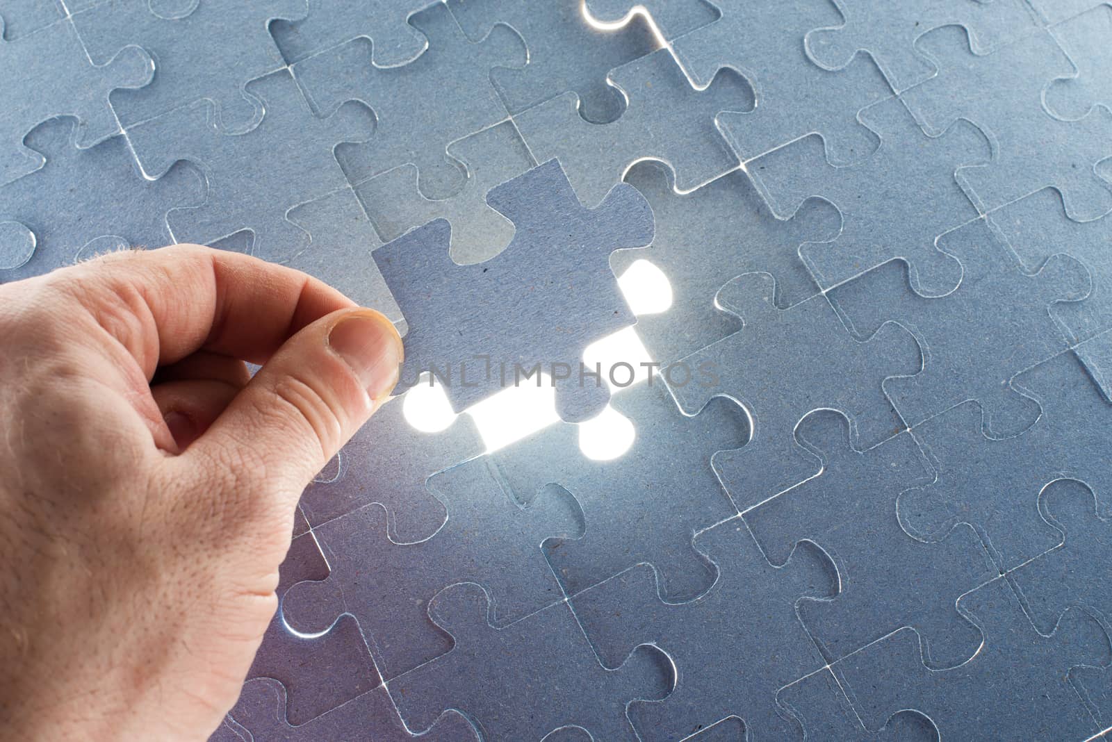 Missing jigsaw puzzle piece with light glow by cherezoff