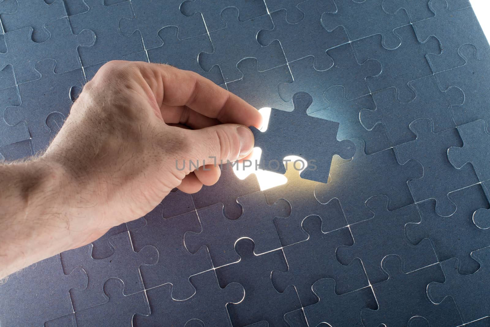 Missing jigsaw puzzle piece with light glow by cherezoff