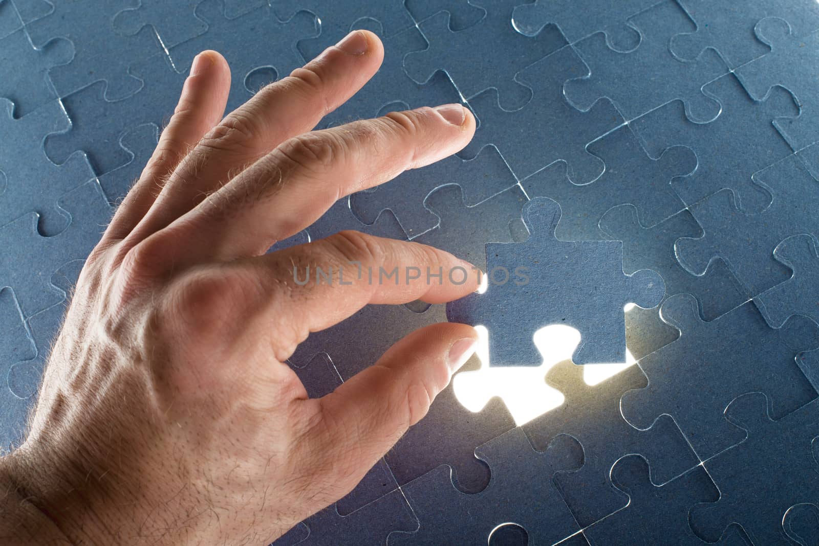 Missing jigsaw puzzle piece with light glow by cherezoff