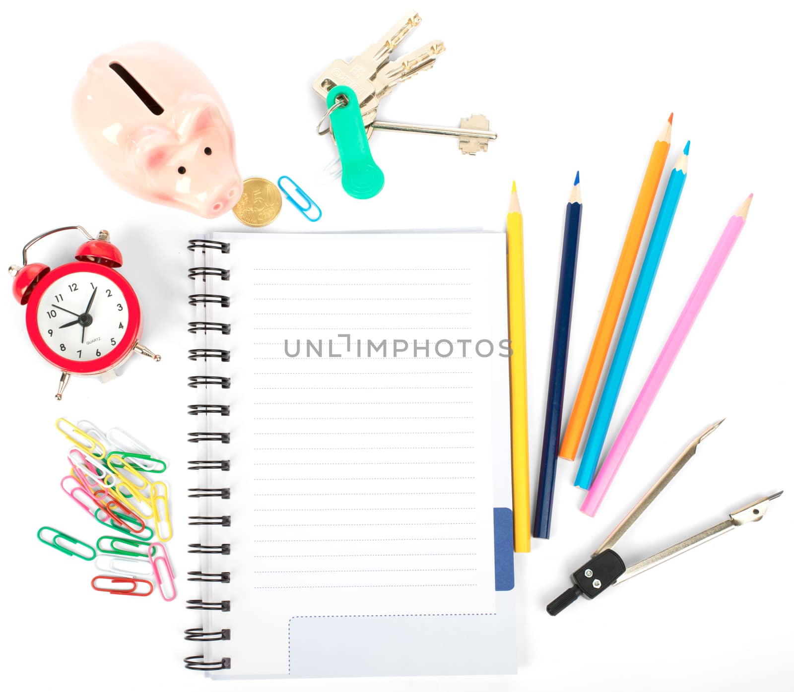 Open notebook with stationery and keys isolated white background, closeup