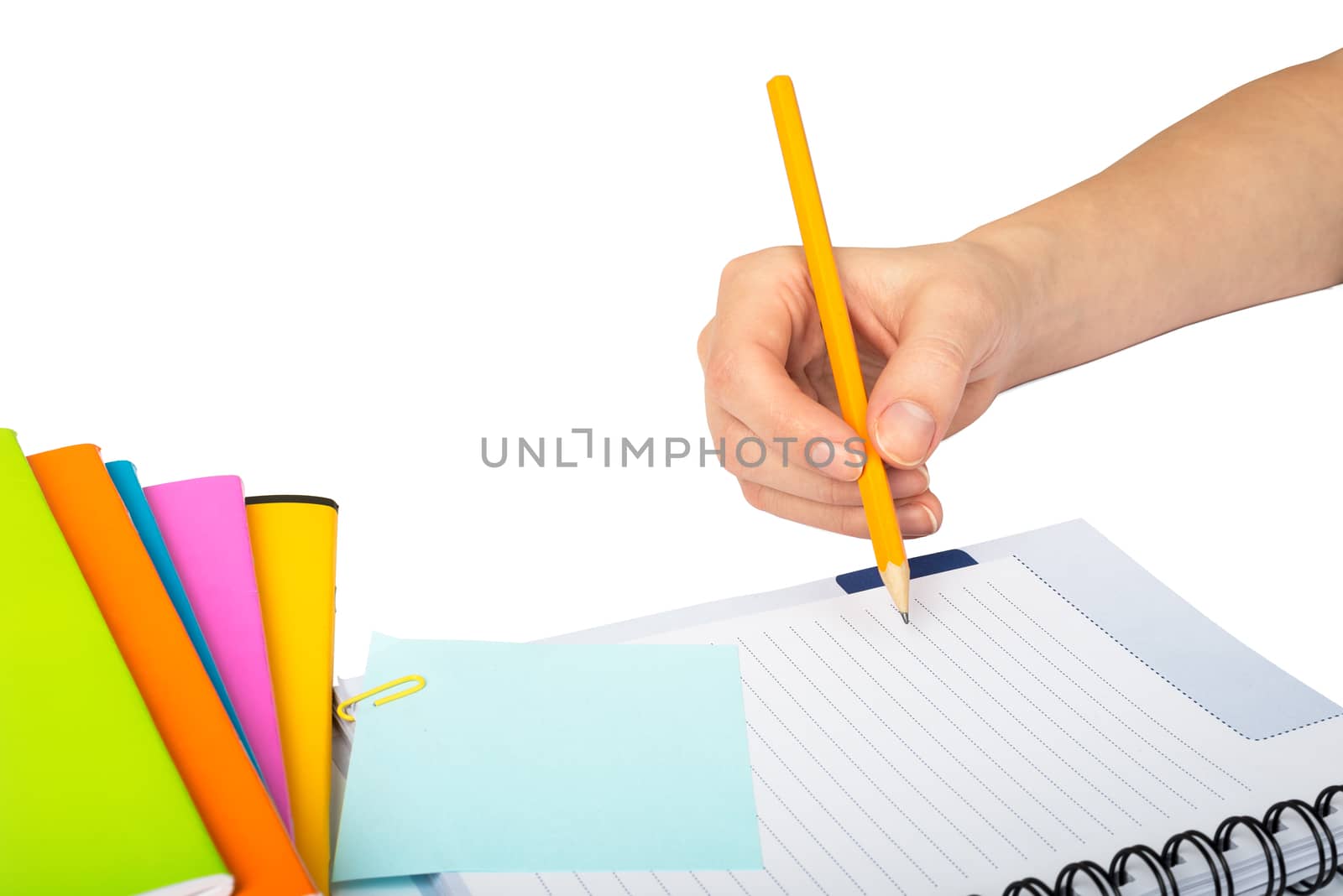 Females hand writing within pen in notebook on isolated white background