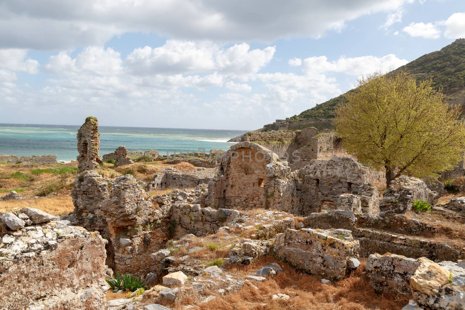 View of historical old area in Anemurium ancient city in Mersin, on cloudy blue sky background.