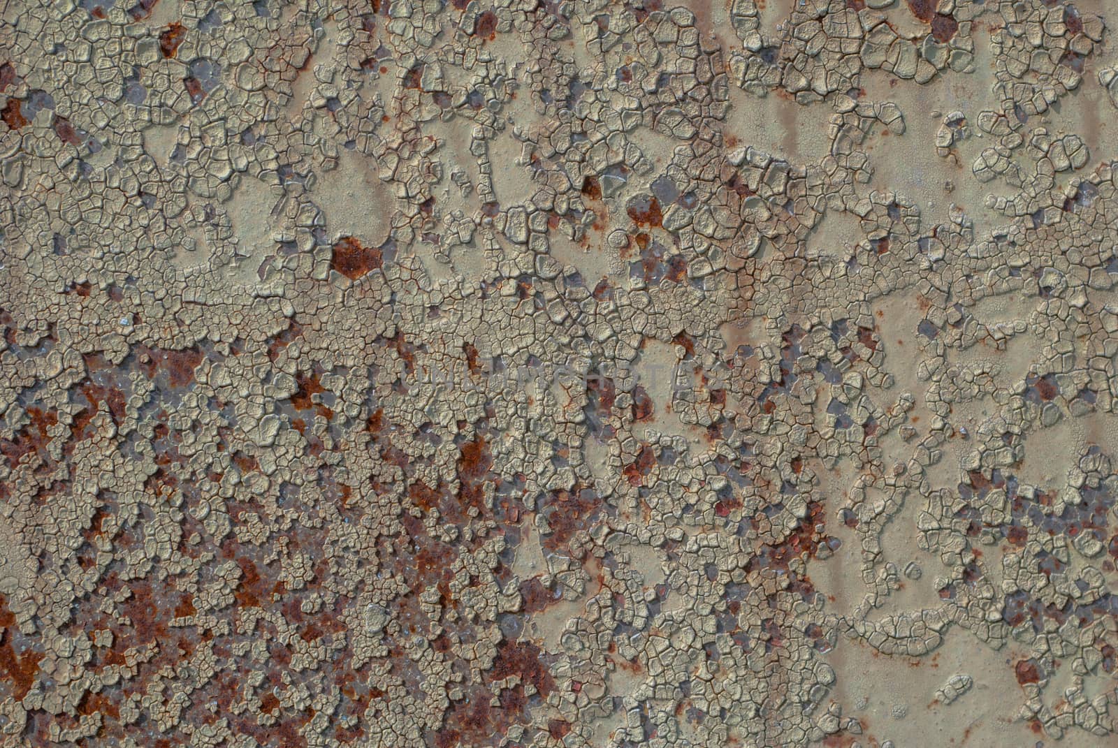 rusty iron surface covered with old chipped paint, which has long been influenced by different climatic conditions