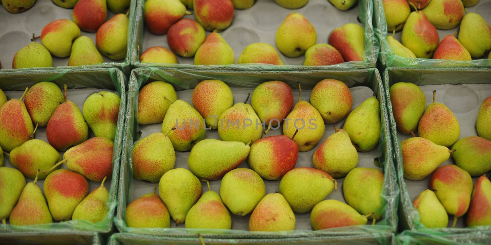 background of ripe juicy pears in market