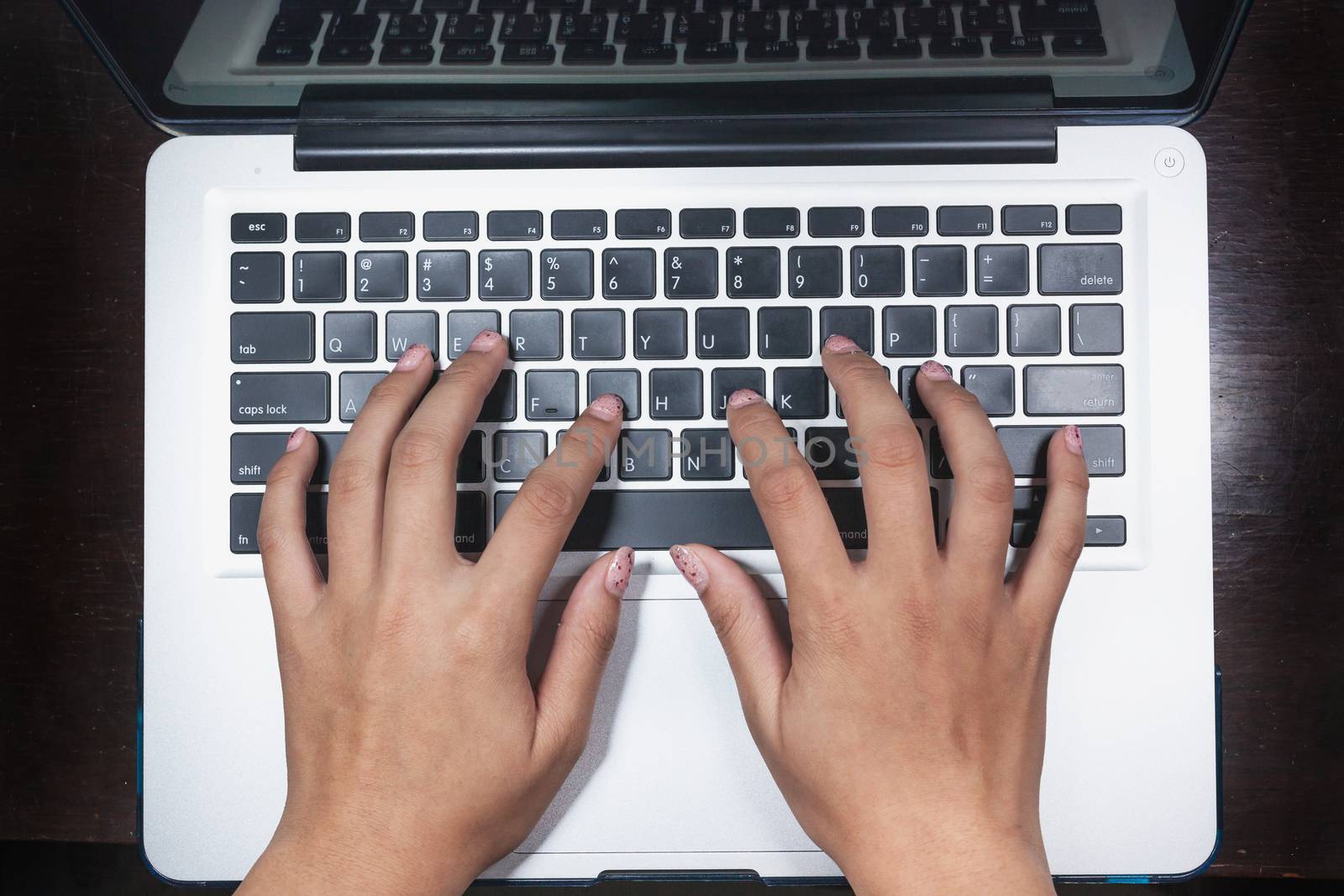 business, education, idea, inspiration and people concept - close up of female hands with paper sheet on computer keyboard