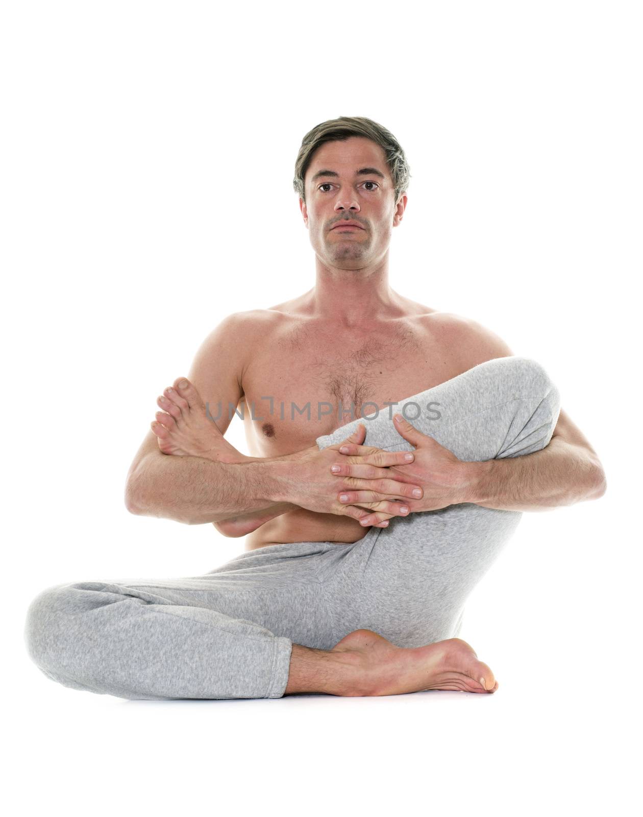 man doing yoga in front of white background