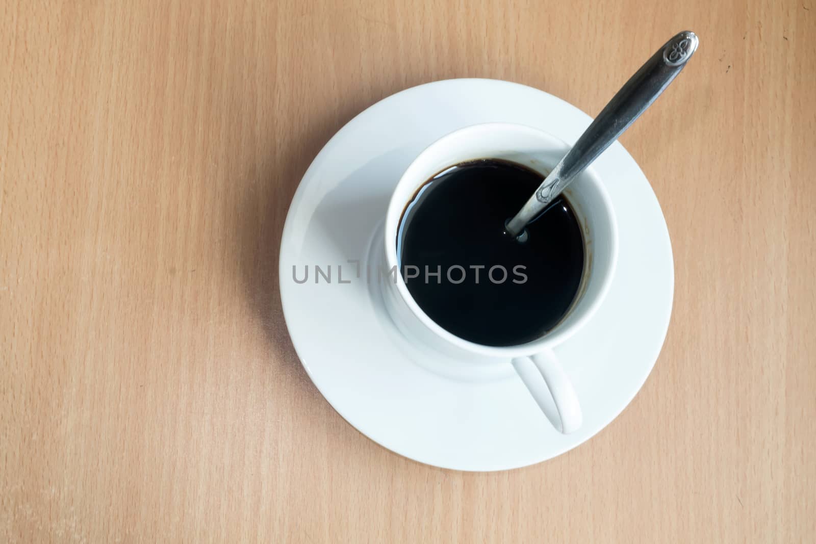 Coffee cup top view on wooden table background by suthee