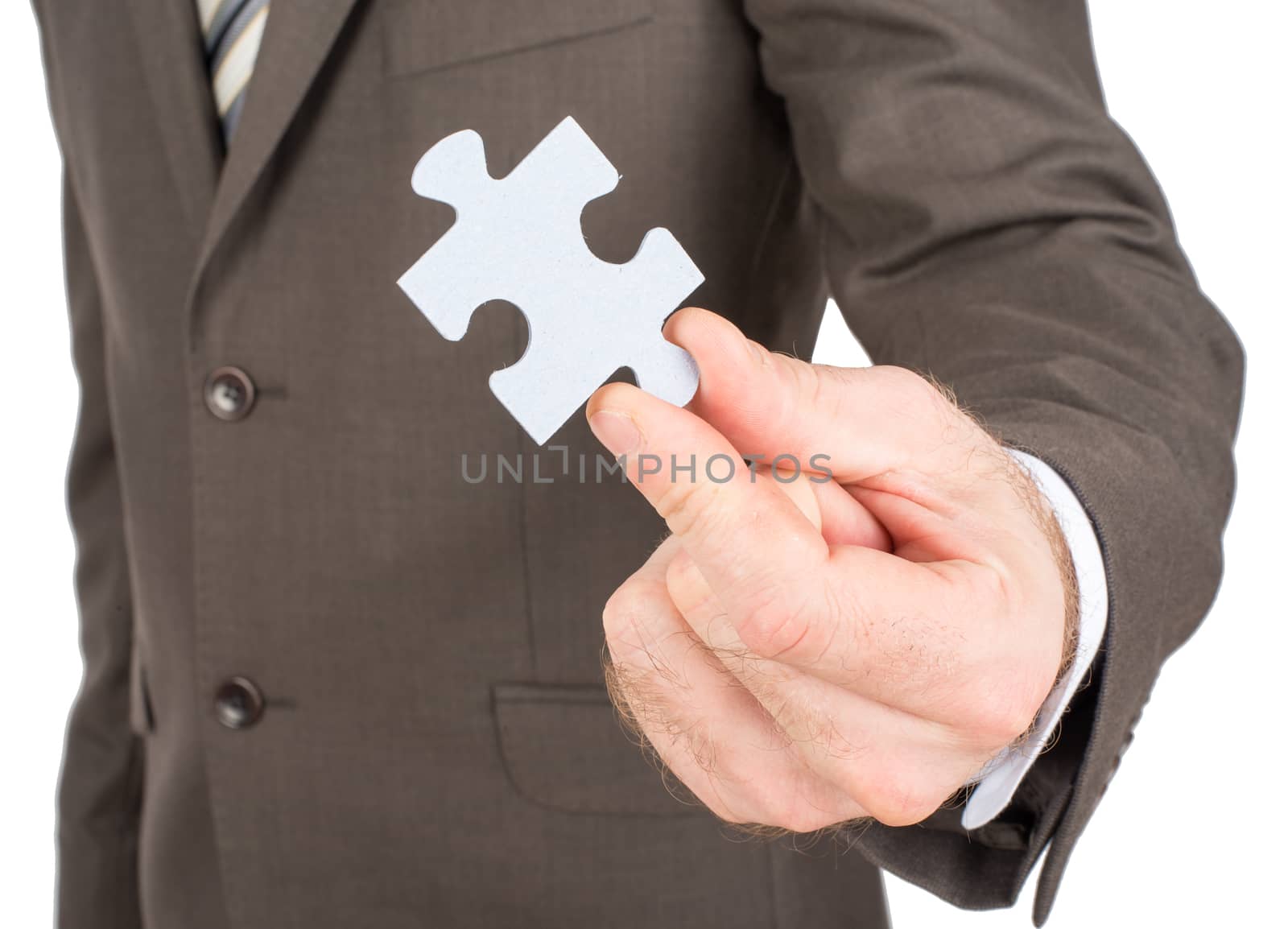 Business man showing jigsaw puzzle piece. Concept for business strength and success.