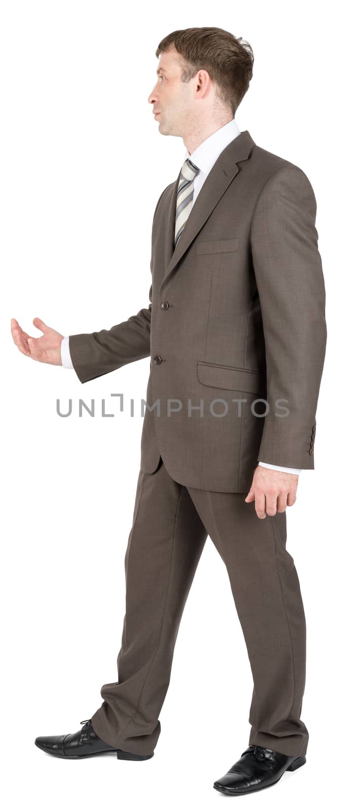 Young businessman in suit keeping palm up isolated on white background, side view