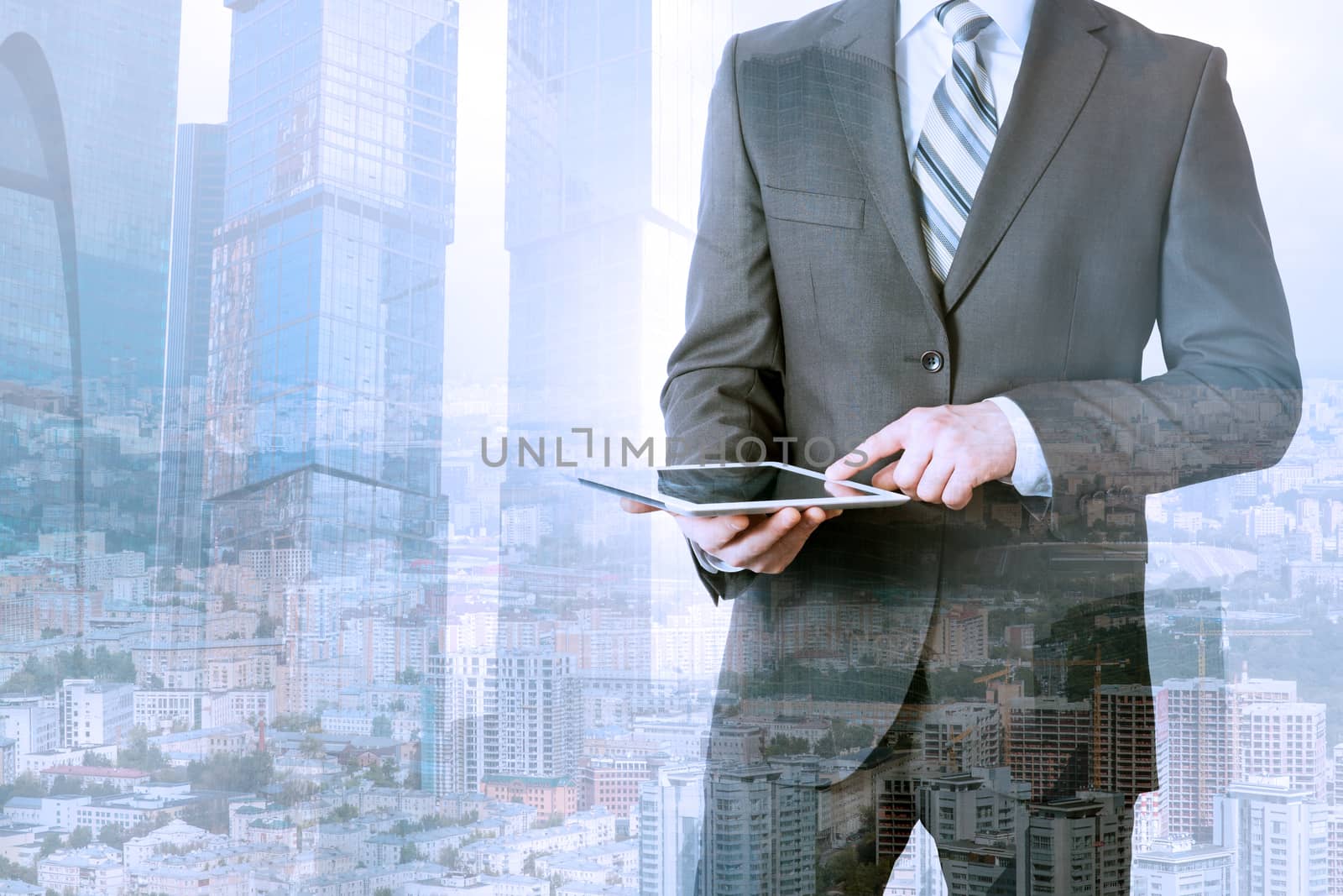 Businessman using tablet on urban city background