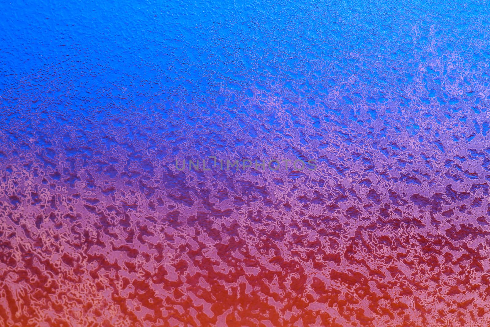 Abstract background. Sunset across a frozen glass