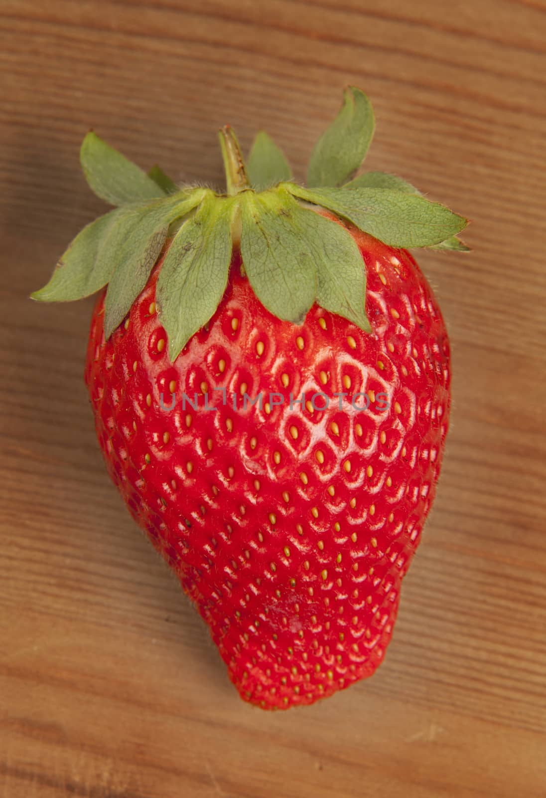 Ripe strawberrie over wooden table background 