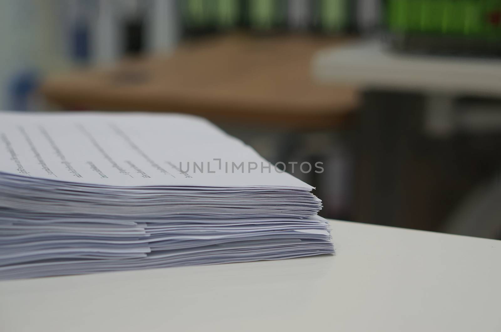 Stack of data work sheet was placed on desk in office.