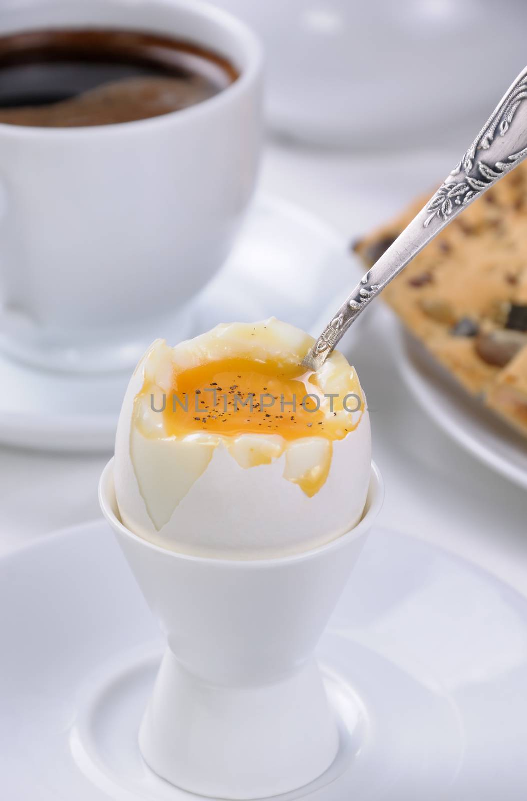 Soft-boiled egg with cup of coffee and crackers for breakfast