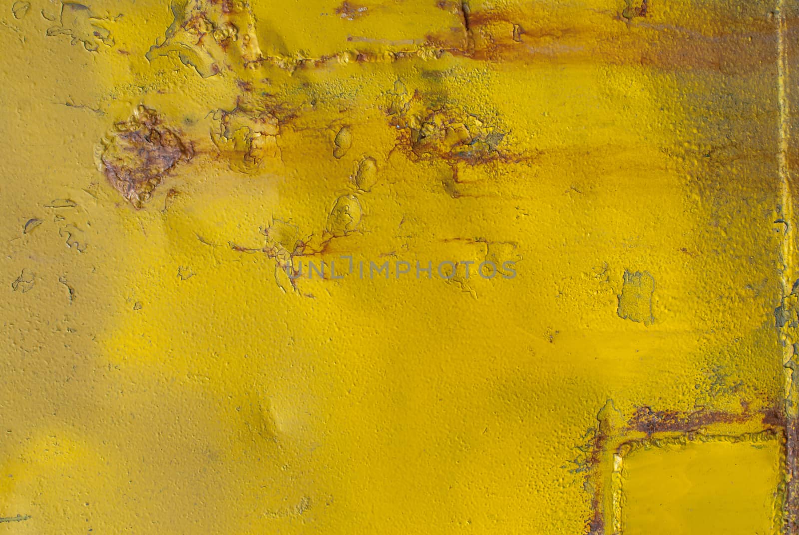 fragment of an iron surface is covered with yellow color paint, which has long been under the influence of different climatic conditions