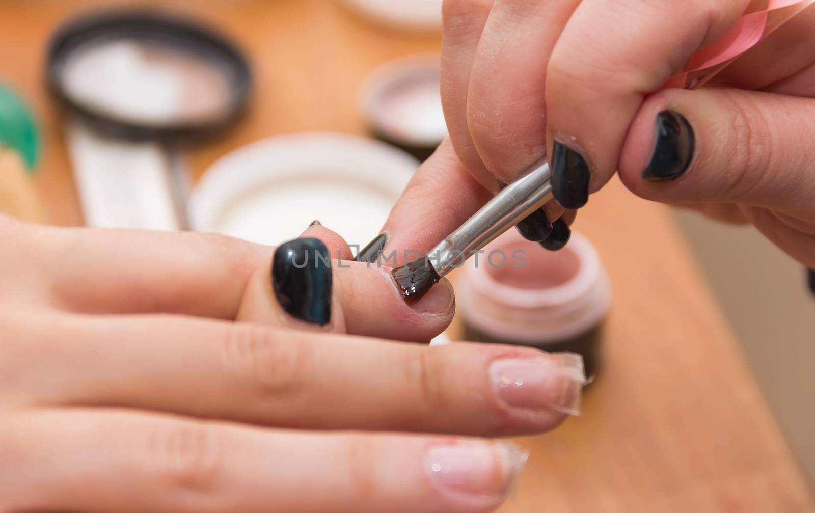 build artificial nails, manicures, artificial nails correction, the industry of beauty and nail care, beauty salons, a process of increasing, in the hands, nail esthetics, soft focus