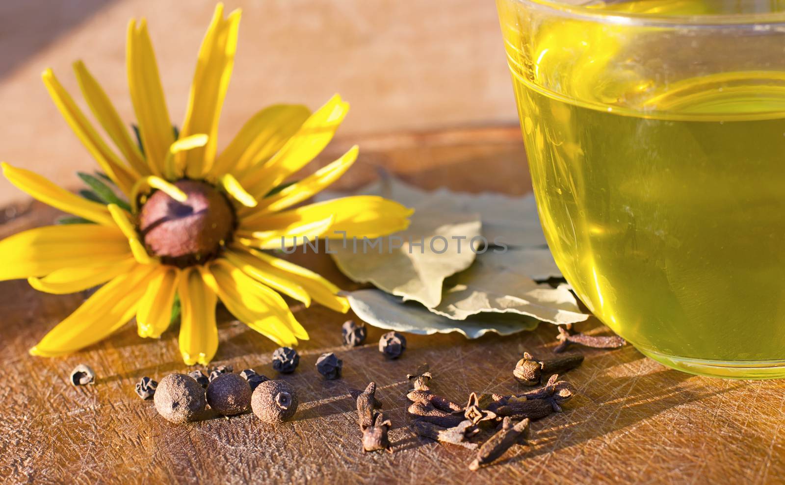 spices, black pepper, allspice, bay leaf, flower, yellow, olive oil, wood background