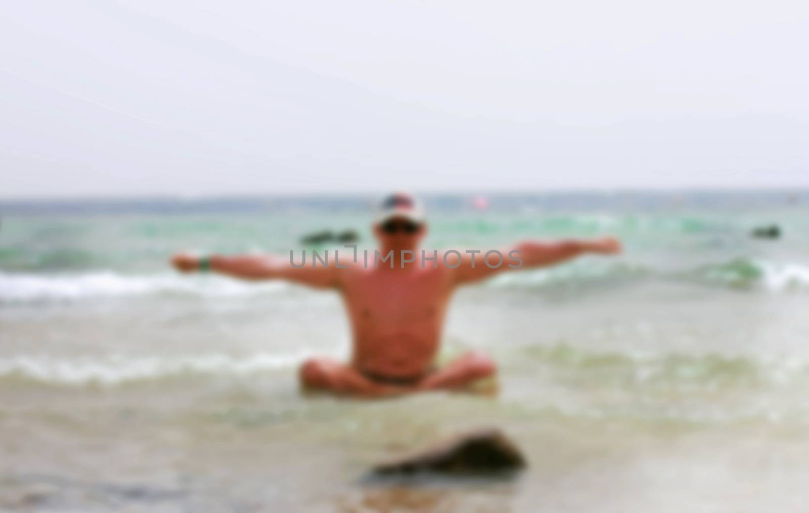 a man on the beach doing yoga, blurred
