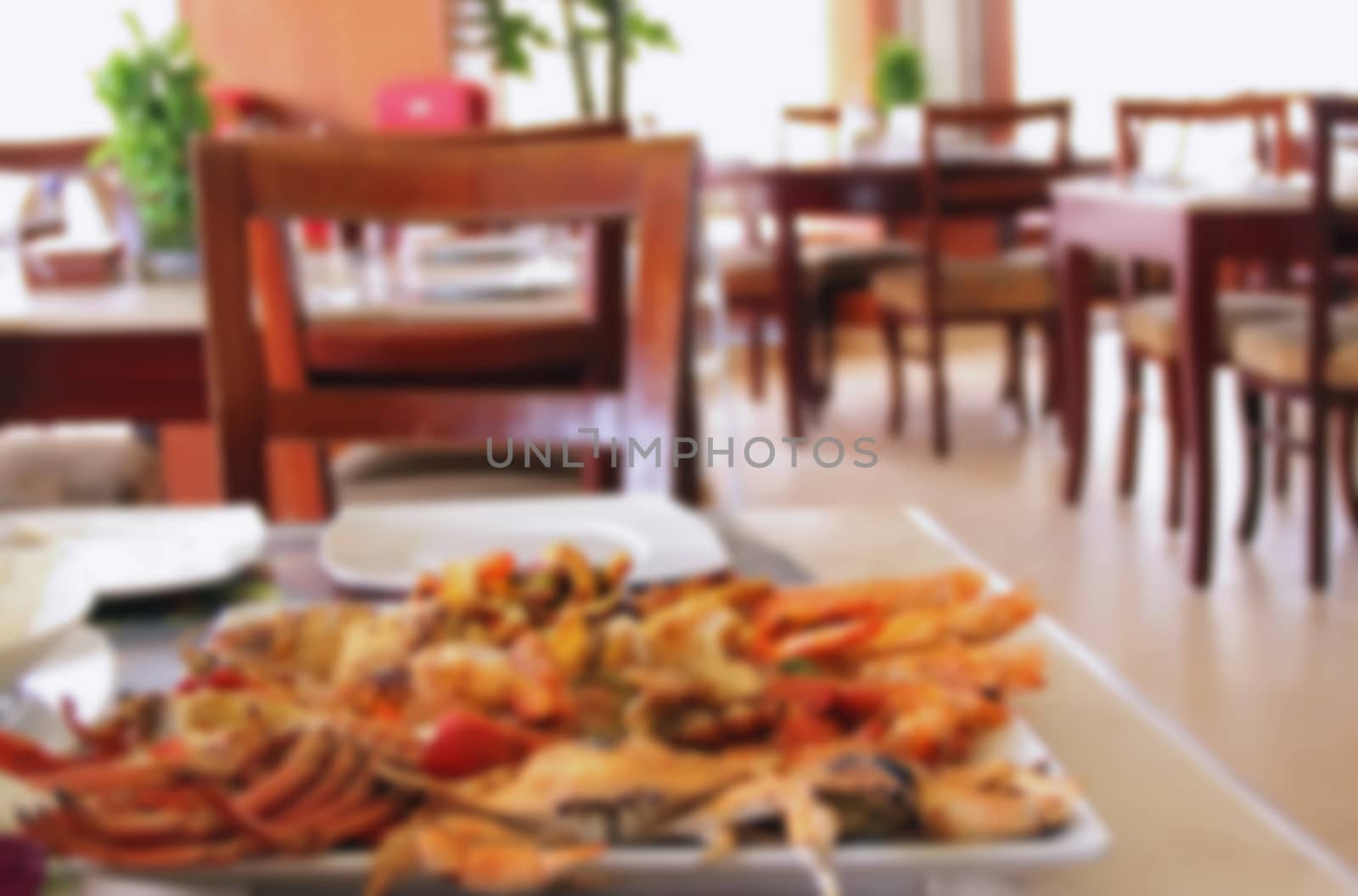 seafood grill in a large plate in a restaurant or cafe decorated table with food, blurred